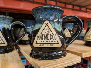 Dark blue beer stein with image of dog on the front.
