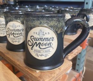 Black coffee mugs with company logo "Summer Moon" coffee shop.