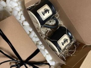 Set of two black coffee mugs with chess piece logo in a brown gift box with black ribbon.